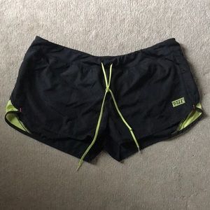 Black and green athletic shorts with built in breathable under where